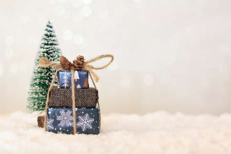 Handmade wooden Christmas truck with christmas gifts on snowy roadの写真素材