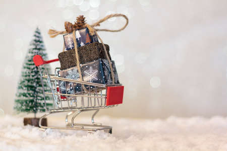 Handmade wooden Christmas truck with christmas gifts on snowy roadの写真素材