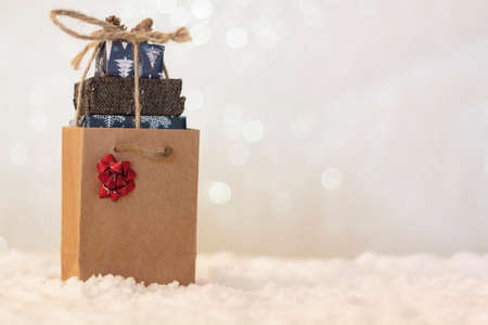 Handmade wooden Christmas truck with christmas gifts on snowy roadの写真素材