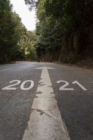 Road with the inscription 2021. Concept of new year arrival with new goals, sucess and futureの写真素材