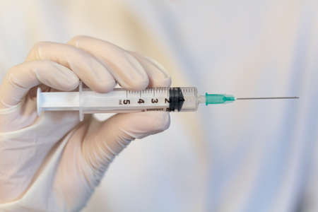 Medic ,scientist, pharmacist holding Syringe. Coronavirus, Covid-19 vaccine conceptの写真素材