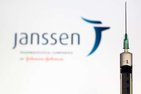 Lisbon, Portugal - November 22, 2020: Syringe and Janssen logo on the background. Coronavirus, Covid-19 vaccine conceptのeditorial素材