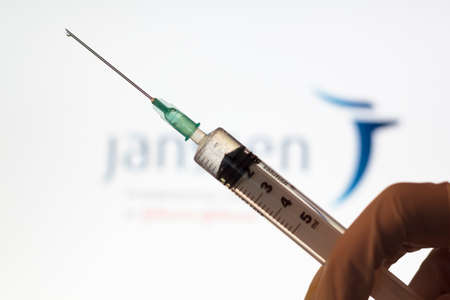 Lisbon, Portugal - November 22, 2020: Syringe and Janssen logo on the background. Coronavirus, Covid-19 vaccine conceptのeditorial素材