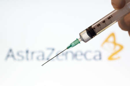 Lisbon, Portugal - November 22, 2020: Syringe and AstraZeneca logo on the background. Coronavirus, Covid-19 vaccine conceptのeditorial素材
