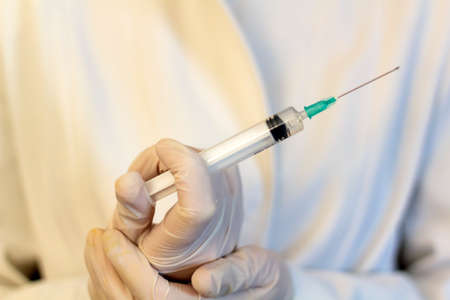 Medic ,scientist, pharmacist holding Syringe. Coronavirus, Covid-19 vaccine conceptの写真素材