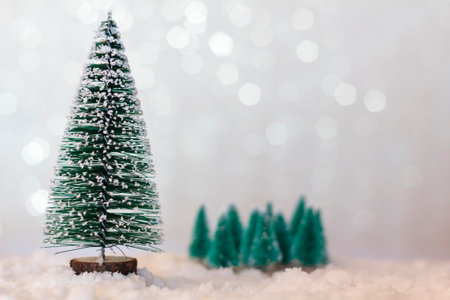 Christmas tree on snow with shiny background with copy spaceの写真素材