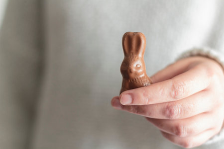 Woman hands holding chocolate Easter bunnyの写真素材