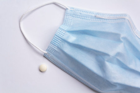 Medical mask and pill. Codiv-19 pill treatment concept