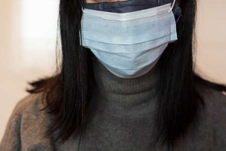 Woman using two face masksの写真素材