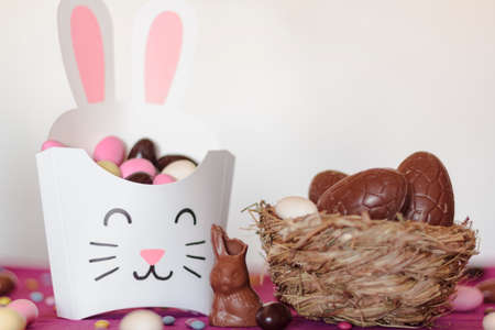 Rabbit treat box with sweet almond eggs and nest with chocolate eggsの写真素材