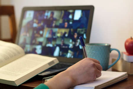 Young woman taking an online class at home. E-learning conceptの写真素材