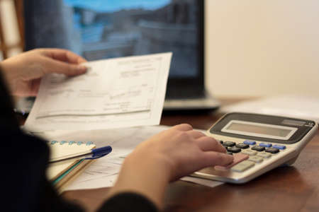 Woman doing financial accounting. Savings, finances and economy conceptの写真素材
