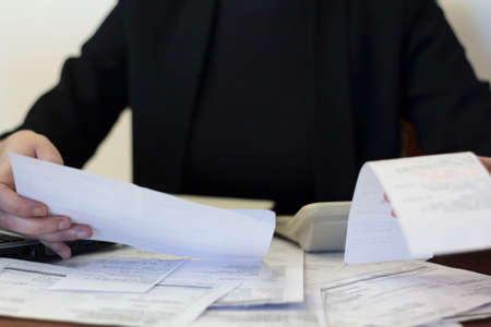 Woman doing financial accounting. Savings, finances and economy conceptの写真素材