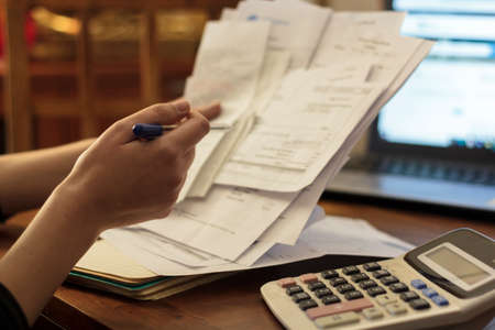 Woman doing financial accounting. Savings, finances and economy conceptの写真素材
