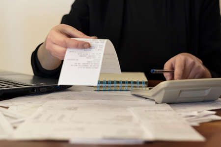 Woman doing financial accounting at home. Savings, finances and economy conceptの写真素材