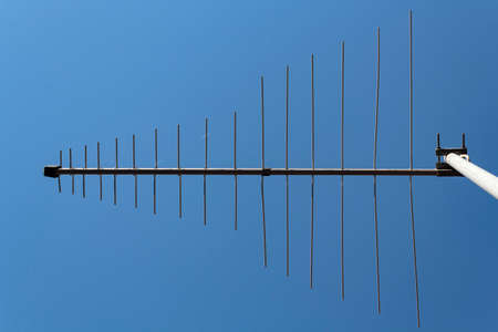 Television antenna against blue skyの写真素材