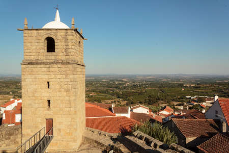 Castle bell tower with village in the backgroundの写真素材