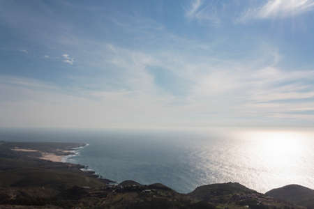 High angle view of coastline, with beach, ocean, blue sky and horizonの写真素材