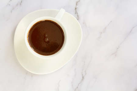 Top view of white cup with hot chocolate drinkの写真素材