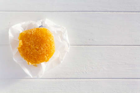 Top view of portuguese sweet bean tart called Pastel de Feijao on white wooden table with copy spaceの写真素材