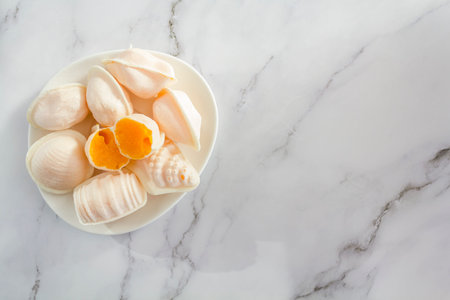 Top view of traditional portuguese sweets called Ovos Moles de Aveiro on marble background with copy spaceの写真素材