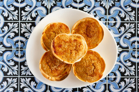 Top view of Traditional Portuguese pastry called Queijada de Sintra on portuguese tiles backgroundの写真素材