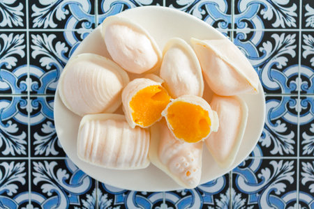 Top view of traditional portuguese egg yolk sweets called Ovos Moles de Aveiro on portuguese tiles backgroundの写真素材