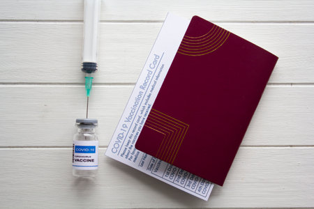 Passport, COVID-19 Vaccination record card and COVID-19 vaccine. Immunity Passport or certificate for travel during COVID-19 pandemicの写真素材