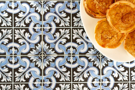Top view of Traditional Portuguese chessecakes called Queijada de Sintra on portugueses tiles background with copy spaceの写真素材