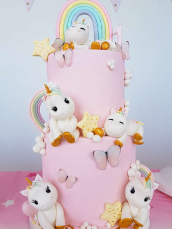 Birthday cake with unicorns and rainbowの写真素材