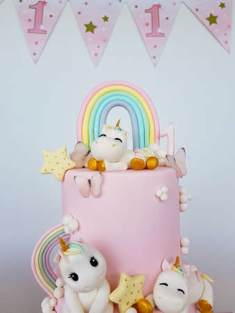 Birthday cake with unicorns and rainbowの写真素材