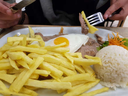 Portuguese cuisine, beef with fried egg and french fries called bitoqueの写真素材
