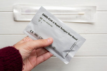 Lisbon, Portugal :12, April 2021- Woman hand holding Covid-19 home test kit, rapid test, self test kitのeditorial素材