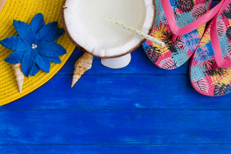 Beach accessories on blue wooden background. Top view with copy spaceの写真素材