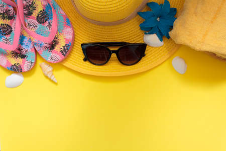 Beach accessories on yellow background with copy spaceの写真素材