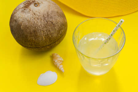 Coconut and coconut water on glass with strawの写真素材