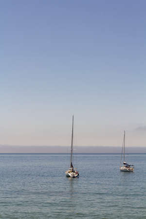 Vertical shot of sailing boats on seaの写真素材