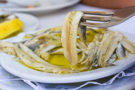 Plate with fish fillet in olive oil and vinegarの写真素材