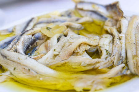 Plate with fish fillet in olive oil and vinegarの写真素材