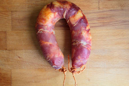 Traditional Portuguese sausage Chorizo on wooden boardの写真素材