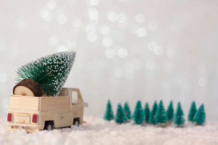 Rear view of truck with christmas tree on snowy background with copy spaceの写真素材
