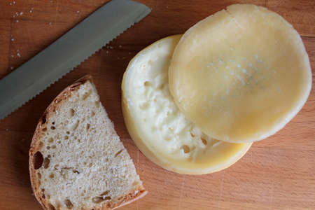 Top view of creamy and soft portuguese cheese with a slice of breadの写真素材