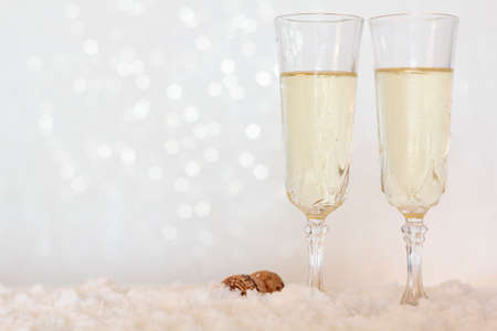 Glasses of champagne on bright background with bokeh effect with copy spaceの写真素材