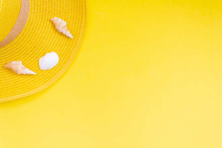 Yellow summer hat on yellow background. Summer concept. Top view with copy spaceの写真素材