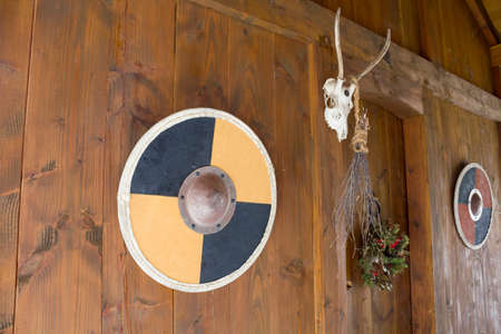 Shields, animal skull and Yule wreath on house entranceの写真素材