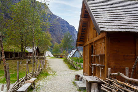 Viking village in Norway with wooden houses, tents with mountains surrounding. Norwegian fjord landscapeの写真素材