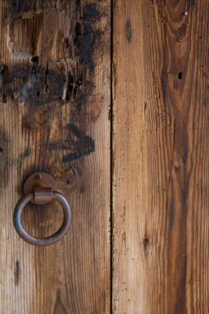 Old wooden door with iron handleの写真素材