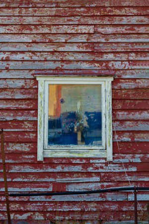Old window on wooden house facadeの写真素材