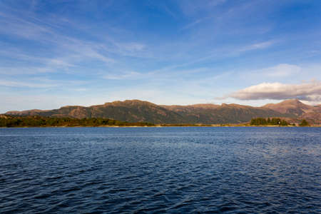 Calm sea with mountains on the backgroundの写真素材