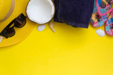 Beach accessories on yellow background. Top view with copy spaceの写真素材
